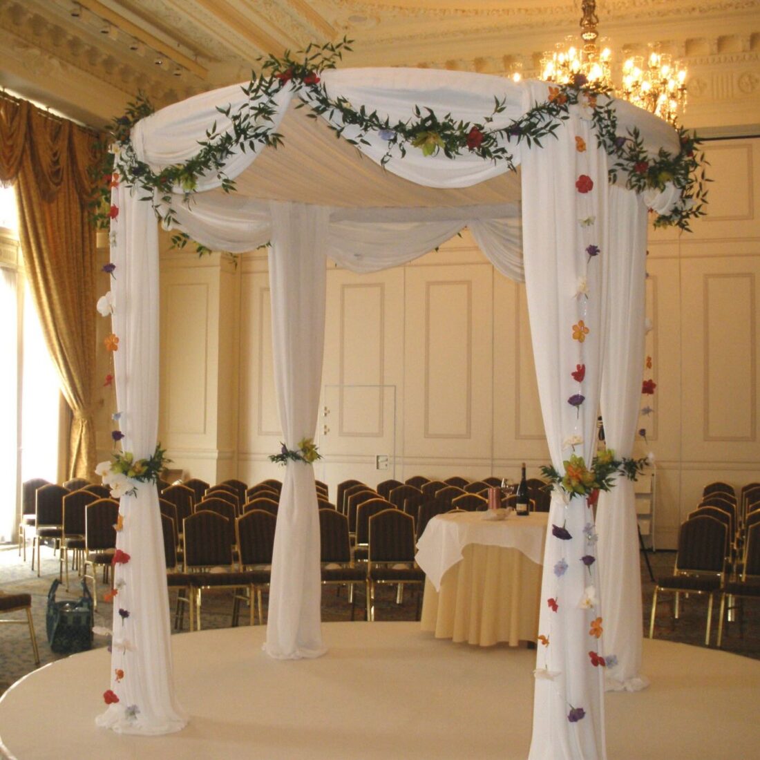 Circular Chuppah - Our signature round silhouette, with a matching circular carpeted stage. No corners, no bad angle.