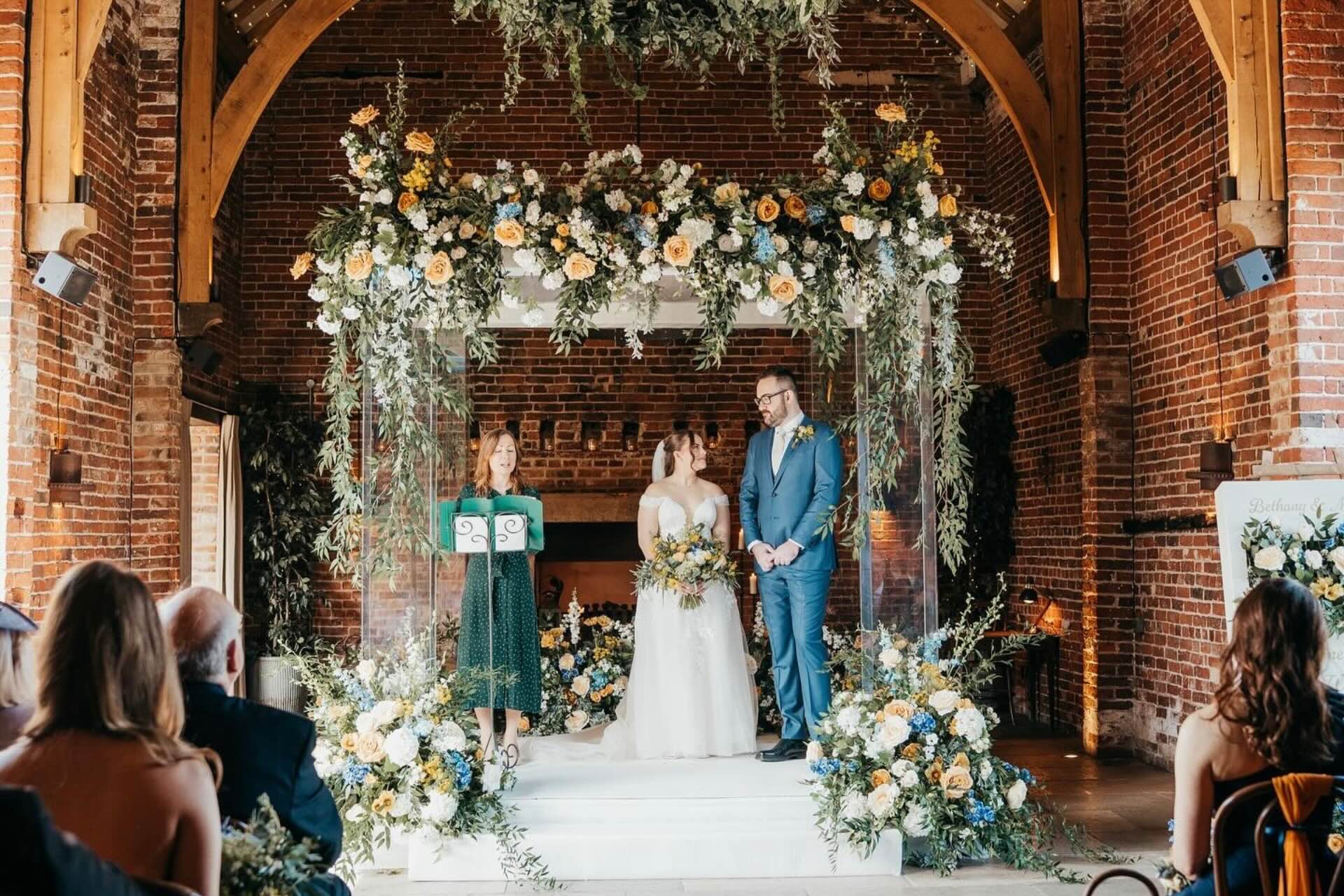 A Jewish wedding ceremony beneath a chuppah in a UK venue