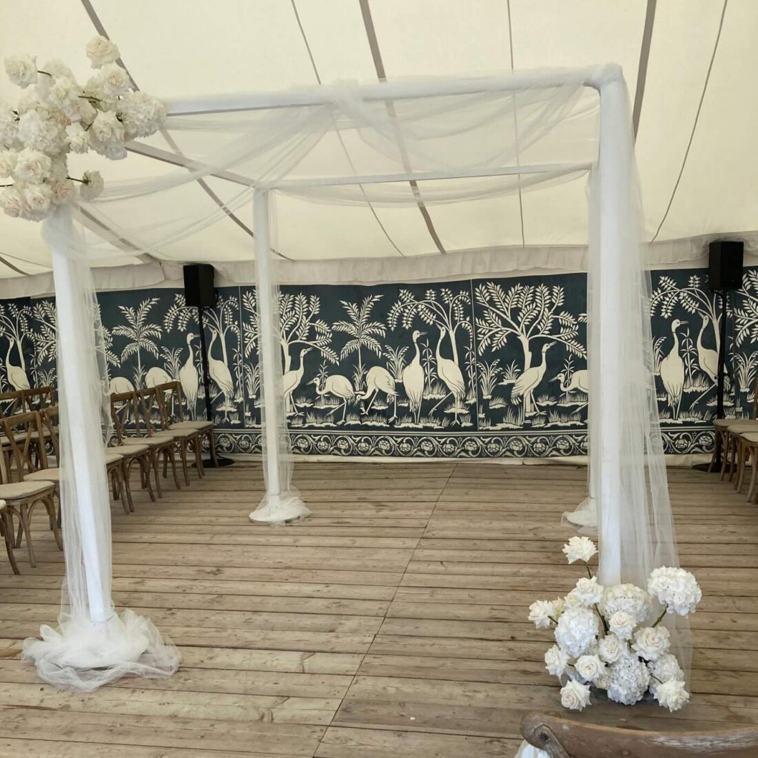White Wood Chuppah - Crisp painted timber. The most versatile frame we hold - bare, draped, or vanishing beneath flowers.